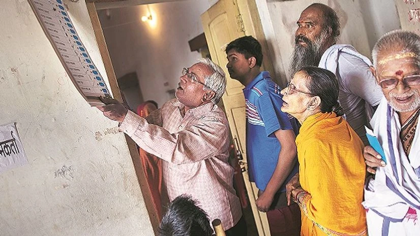 Voters looking at a placard displaying election symbols of various political parties at a polling station in Varanasi, UP. File photo: Reuters Voters looking at a placard displaying election symbols of various political parties at a polling station in Varanasi, UP. File photo: Reuters