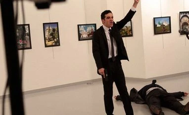 Vladimir Putin orders security reinforcement after envoy's assassination A man gestures near to the body of Russian envoy Andrey Karlov at a photo gallery in Ankara, Turkey. Photo: AP/PTI