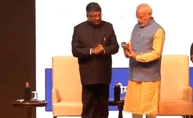 Digi-Dhan Mela: Modi launches mobile app to promote digital transactions Prime Minister Narendra Modi launches a mobile application to promote digital transaction. Photo: Twitter(@BJP4India)