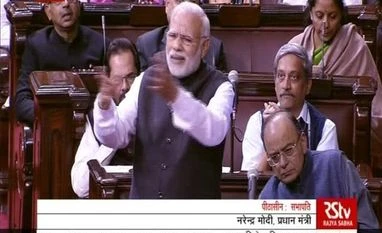 Outraged Congress walks out in RS over Modi's 'raincoat' jibe at Manmohan Modi