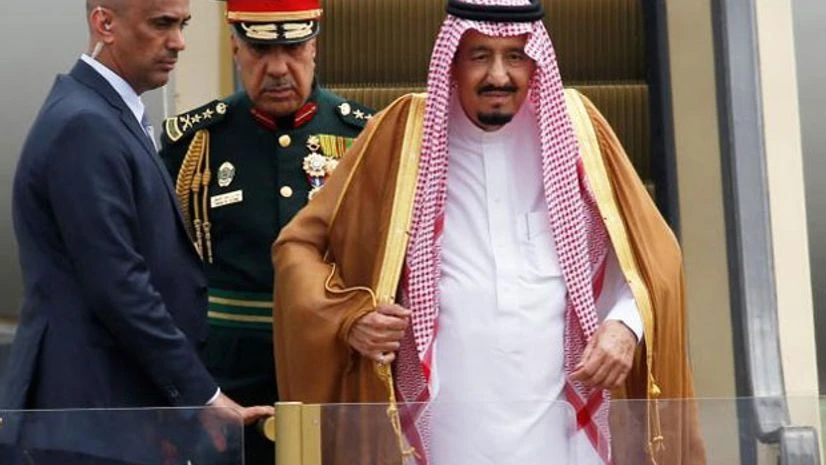 Saudi Arabia's King Salman (R) stands on an escalator Saudi Arabia's King Salman (R) stands on an escalator