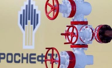 Rosneft says Essar takeover is done pending final details The logo of Russian state oil company Rosneft is pictured behind a pipe at the Samotlor oil field outside the of Nizhnevartovsk, Russia