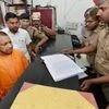 UP Chief Minister Yogi Adityanath speaking with a police personnel during a surprise visit at the Hazratganj police station in Lucknow (Photo: PTI)