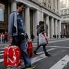 People cross Broadway with shopping bags in Manhattan, New York City, US