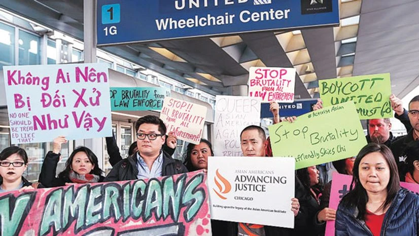 Community members protest the treatment of David Dao, who was forcibly removed from a United Airlines flight on Sunday by the Chicago Aviation Police, at O'Hare International Airport in Chicago. Photo: Reuters Community members protest the treatment of David Dao, who was forcibly removed from a United Airlines flight on Sunday by the Chicago Aviation Police, at O'Hare International Airport in Chicago. Photo: Reuters