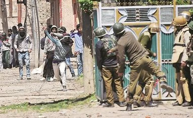 Normal life hit in Kashmir due to separatists' strike against BSF jawans Youths throw stones on Security forces during clashes in Srinagar on Sunday. Four civilians where killed and more than two dozens were injured during the clashes. Photo: PTI