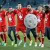 Bayern's Arturo Vidal wears a mock trophy as he and his teammates celebrate winning the German soccer champion title after the Bundesliga soccer match against VfL Wolfsburg in Wolfsburg, Germany