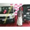 Sunil Kumar P S with the autorickshaw he modified to look like a Mahindra Scorpio (right)
