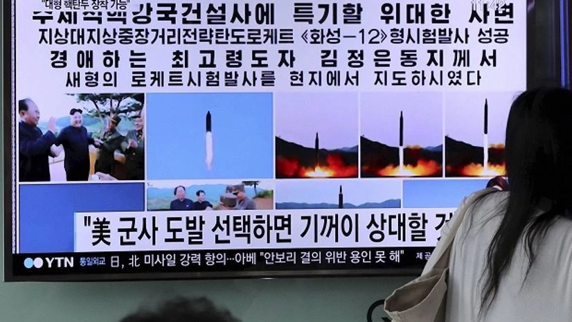 Woman walks by a TV news program showing images of North Korean leader Kim Jong Un and the missile launch, published in the country's Rodong Sinmun newspaper, at Seoul Railway station in Seoul, South Korea. File Photo: PTI Woman walks by a TV news program showing images of North Korean leader Kim Jong Un and the missile launch, published in the country's Rodong Sinmun newspaper, at Seoul Railway station in Seoul, South Korea. File Photo: PTI