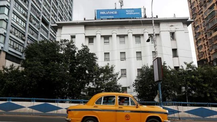 A taxi drives past a Reliance Communications office building in Kolkata. Photo: Reuters A taxi drives past a Reliance Communications office building in Kolkata. Photo: Reuters