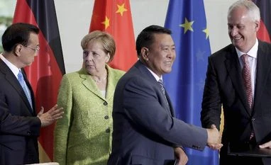 China makes concessions to Germany to boost e-car production German Chancellor Angela Merkel, second from left, and China's Premier, Li Keqiang, left, attend a contract signing ceremony between Xu Heyi, Chairman of the Beijing Automotive Group BAIC, and Hubertus Troska, right, board member of the Daimler AG a