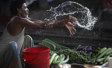 Bangladesh announces $50 billion budget to spur economy A vendor splashes water as he sells vegetable next to a railway track in Dhaka.(Photo: Reuters)