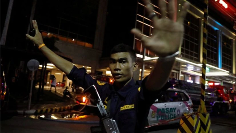 A security guard stops photographers from entering the area near Resorts World Manila, after gunshots and explosions were heard in Pasay City, Metro Manila, Philippines June 2, 2017. Photo: Reuters A security guard stops photographers from entering the area near Resorts World Manila, after gunshots and explosions were heard in Pasay City, Metro Manila, Philippines June 2, 2017. Photo: Reuters
