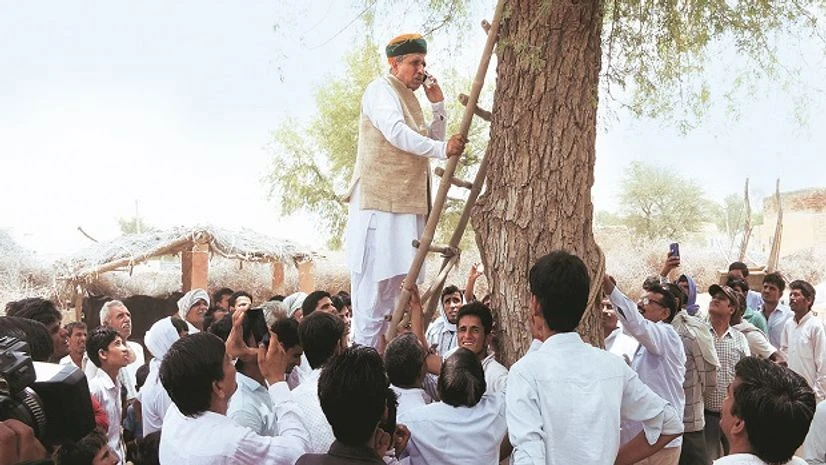 Arjun Ram Meghwal Union Minister of State for Finance Arjun Ram Meghwal climbs a tree to get signal for a phone call in Bikaner. Photo: PTI