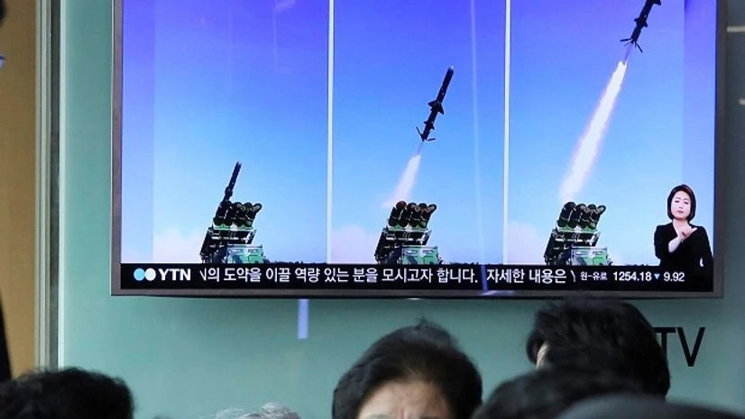 North Korea, surface to ship missile A man watches a TV news program showing photos published in North Korea's Rodong Sinmun newspaper of North Korea's new type of cruise missile launch, at Seoul Railway station in Seoul, South Korea June 9.