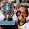 Latvia's Jelena Ostapenko holds the cup after defeating Romania's Simona Halep in their final match of the French Open tennis tournament at the Roland Garros stadium