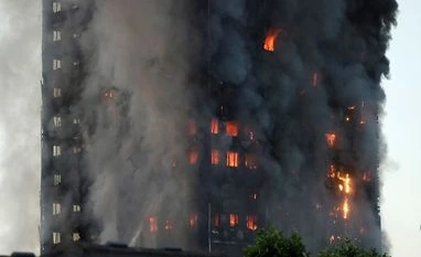 London fire: Man catches baby dropped from 10th floor Flames rise from building on fire in London, Wednesday, June 14, 2017. Metropolitan Police in London say they're continuing to evacuate people from a massive apartment fire in west London. Photo: AP/PTI