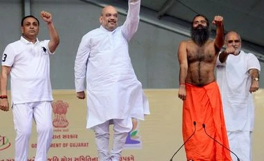 The Subrata Roy connection: The many things we don't know about Baba Ramdev National President of BJP Amit Shah (C), Gujarat Chief Minister Vijay Rupani (L) and Yoga guru Baba Ramdev perform Yoga on the occasion of 3rd International Yoga Day at GMDC ground in Ahmedabad on Wednesday. Photo: PTI
