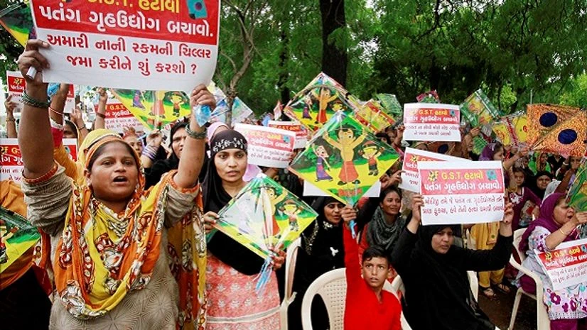 Kites workers hold placards and shout slogans during a protest against implementation of Good and service Tax GST in Ahmedabad on Saturday. Photo: PTI Kites workers hold placards and shout slogans during a protest against implementation of Good and service Tax GST in Ahmedabad on Saturday. Photo: PTI