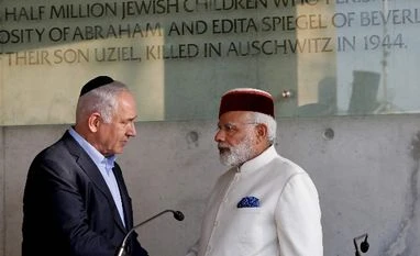 PM Modi to meet Moshe, the toddler who survived 26/11 attacks, in Jerusalem Jerusalem : Indian Prime Minister Narendra Damodardas Modi, right, shakes hands with Israeli Prime Minister Benjamin Netanyahu after signing the guestbook at the Yad Vashem Holocaust memorial museum in Jerusalem, Tuesday, July 4 2017. Photo: PTI