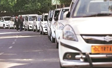 Ola, Uber drivers in major cities to go on an indefinite strike from today Drivers of Uber and Ola walk next to their parked vehicles during a protest in New Delhi in February 2017. Photo: Reuters