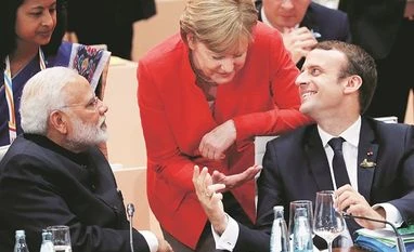 G20 Summit 2017: PM Modi pitches for global deterrent action against terror French President Emmanuel Macron with German Chancellor Angela Merkel and Prime Minister Narendra Modi during the G20 leaders summit in Hamburg