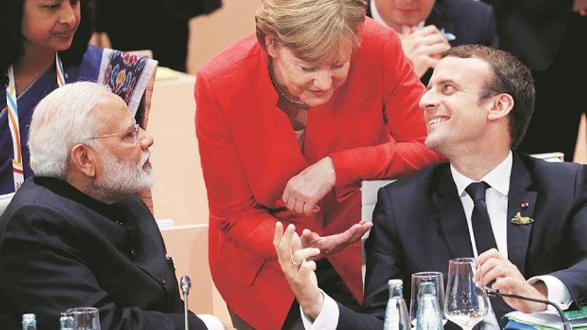 French President Emmanuel Macron with German Chancellor Angela Merkel and Prime Minister Narendra Modi during the G20 leaders summit in Hamburg French President Emmanuel Macron with German Chancellor Angela Merkel and Prime Minister Narendra Modi during the G20 leaders summit in Hamburg