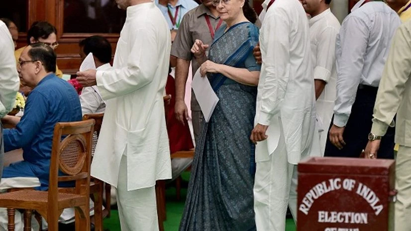 Electoral College, Presidential election New Delhi: Congress president Sonia Gandhi with party Vice president Rahul Gandhi wait to cast vote in the Presidential Election, in New Delhi on Monday. PTI Photo