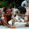 Group of Yugambeh Aboriginal warriors men demonstrate fire making craft during Aboriginal culture show in Queensland, Australia. Photo: Shutterstock