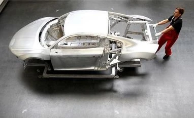 manufacturing A worker moves a new Audi R8 car body in the automotive welding and assembly lines hall of the German car manufacturer's plant. Photo: Reuters