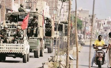 Uneasy calm returns after Dera violence Army personnel conduct a flag march after their deployment near Dera Sacha Sauda’s headquarters in Sirsa on Saturday photo: pti