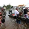 Friendswood  : Neighbors use their personal boats to rescue Friendswood, Texas residents stranded by flooding Sunday, Photo: AP/PTI