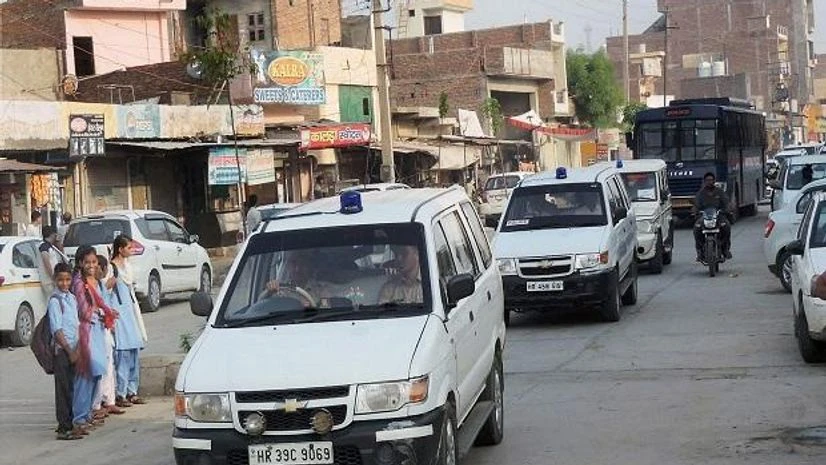 Sirsa: Vehicles of a search team on their way to Dera Sacha Sauda in Sirsa on Friday, ahead of the search operations inside the headquarters. PTI Photo Sirsa: Vehicles of a search team on their way to Dera Sacha Sauda in Sirsa on Friday, ahead of the search operations inside the headquarters. PTI Photo