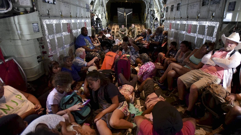 Hurricane Irma US Air force personnel evacuate citizens aboard an aircraft after the passage of Hurricane Irma, in St. Martin.(Photo: AP|PTI)