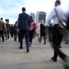 Workers cross London Bridge during the morning rush hour in London. Photo: Reuters