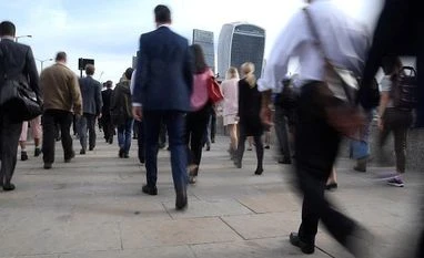 UK unemployment rate falls to lowest since 1975 as pay growth lags Workers cross London Bridge during the morning rush hour in London. Photo: Reuters