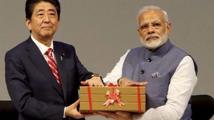 Prime Minister Narendra Modi and Shinzo Abe Gandhinagar: Prime Minister Narendra Modi greets the Prime Minister of Japan, Shinzo Abe inaugurate Ahmedabad's Maruti Suzuki plant, during India-Japan Annual Summit at Mahatma Mandir in Gandhinagar in Gujarat on Thursday. PTI Photo