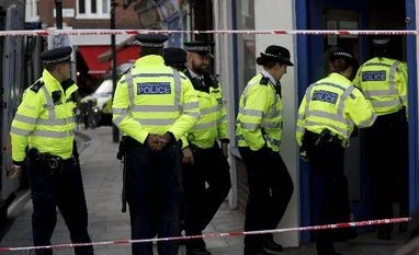 London tube attack: IS claims responsibility, terror alert level 'critical' Police enter a building near Parsons Green subway station in London (Photo: AP/PTI)