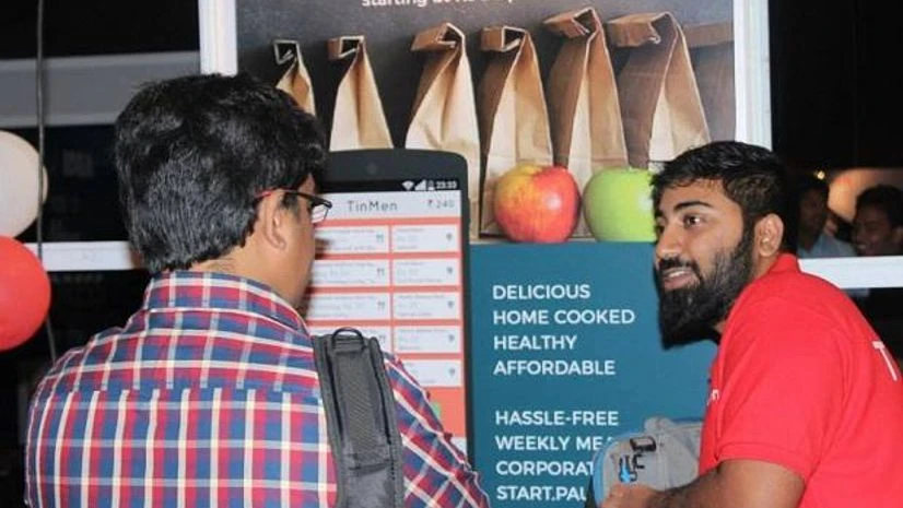 TinMen founder Mukesh Manda (right) explaining an early version of the app to a user TinMen founder Mukesh Manda (right) explaining an early version of the app to a user