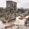 Vehicles ply on a flooded road following heavy rain in Hyderabad on Tuesday. 	Photo: PTI