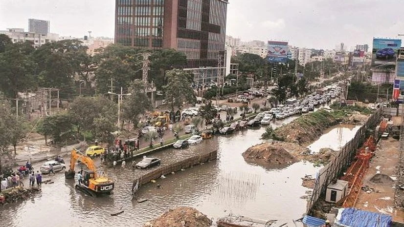Vehicles ply on a flooded road following heavy rain in Hyderabad on Tuesday Photo: PTI Vehicles ply on a flooded road following heavy rain in Hyderabad on Tuesday. Photo: PTI