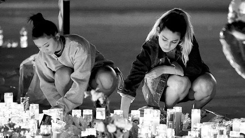 Las Vegas attack Women light candles at a vigil on the Las Vegas strip, following a mass shooting.