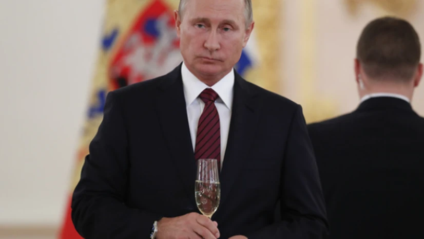 Vladmir Putin Russian President Vladimir Putin holds a glass of champagne during a ceremony to receive credentials from foreign ambassadors at the Kremlin in Moscow.(Photo: Reuters)
