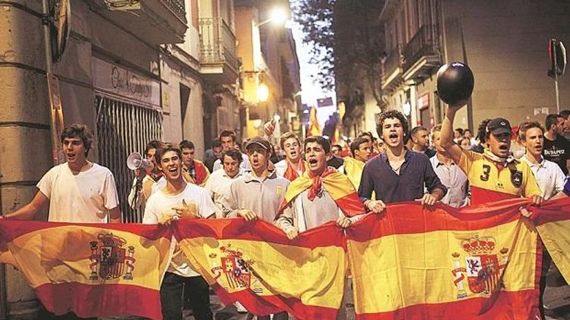 Catalonia Anti-Catalan independence demonstrators carry a Spanish flag as they march in Barcelona, Spain photo: pti