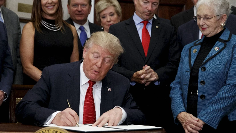 Donald Trump, healthcare subsidies, healthcare, Obamacare President Donald Trump signs an executive order on health care in the Roosevelt Room of the White House in Washington. (Photo: AP| PTI)