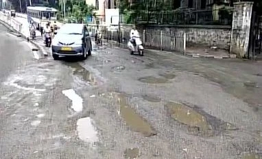 Bengaluru rains: 16-year-old girl drowns in drain, toll mounts to 10 Bengaluru: Visuals of potholes-infested road near Anand Rao Circle. Photo: ANI