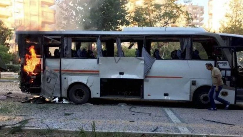 Turkish police officers A bus carrying police officers still burning shortly after a bomb went off as the bus was passing by in Mersin in southern Turkey. (Photo: AP| PTI)
