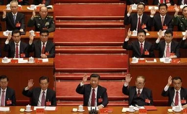 Xi as powerful as Mao as CCP enshrines his thoughts into constitution Chinese President Xi Jinping, front row center, leads other cadres to raise their hands to show approval of work reports during the closing ceremony for the 19th Party Congress at the Great Hall of the People in Beijing. (Photo: AP|PTI)