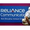 A man walks past a logo of Reliance Communication before the Annual General Meeting in Mumbai. (Photo: Reuters)