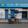 Canara Bank A rickshaw puller passes the Canara Bank branch in the old quarters of Delhi. Photo: Reuters